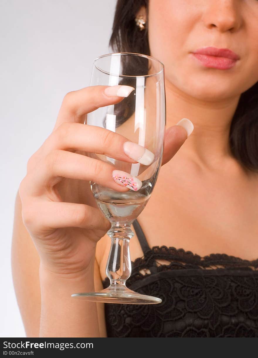 Brunette girl with glass of wine on the white background