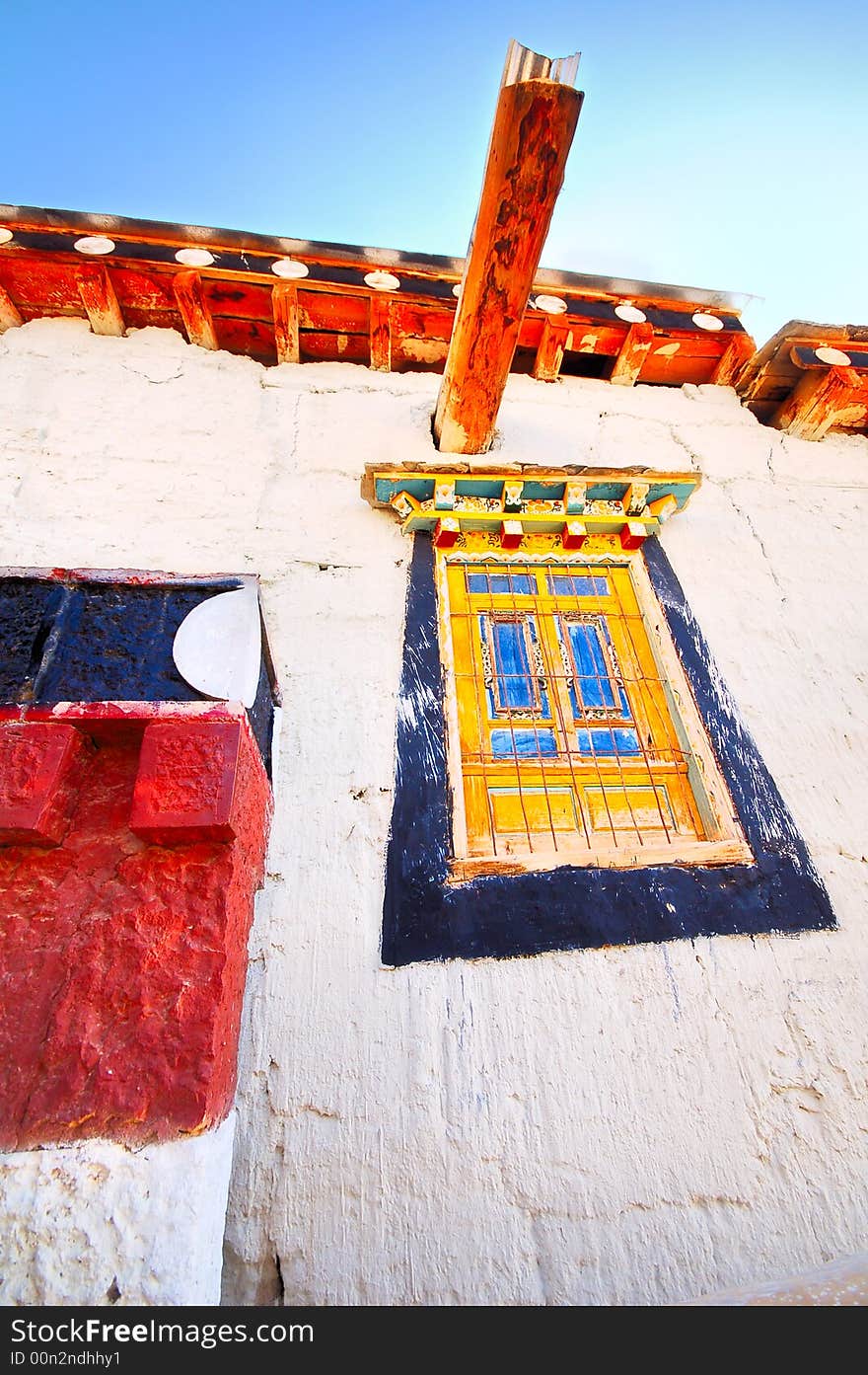 It's Tibet style house with tradition wood windows and white wall.