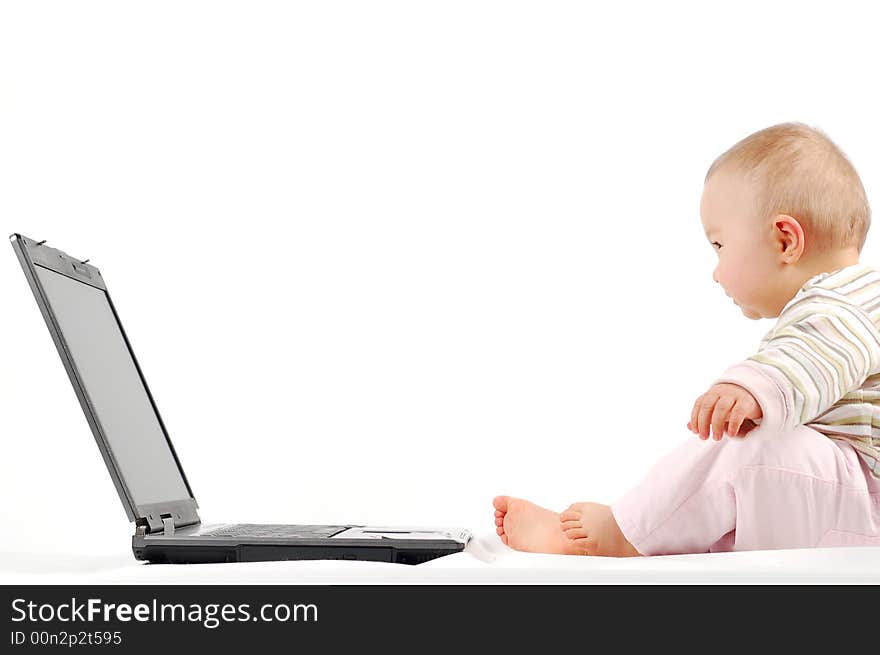 Sweet happy baby girl having fun with laptop on white background. Sweet happy baby girl having fun with laptop on white background