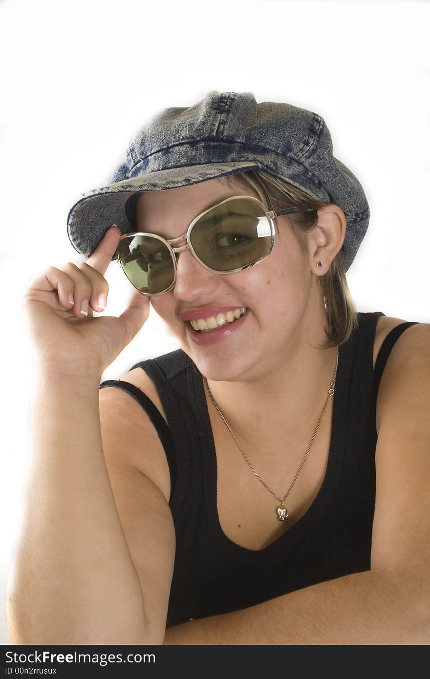 Portrait of a young attractive woman with glasses and cap