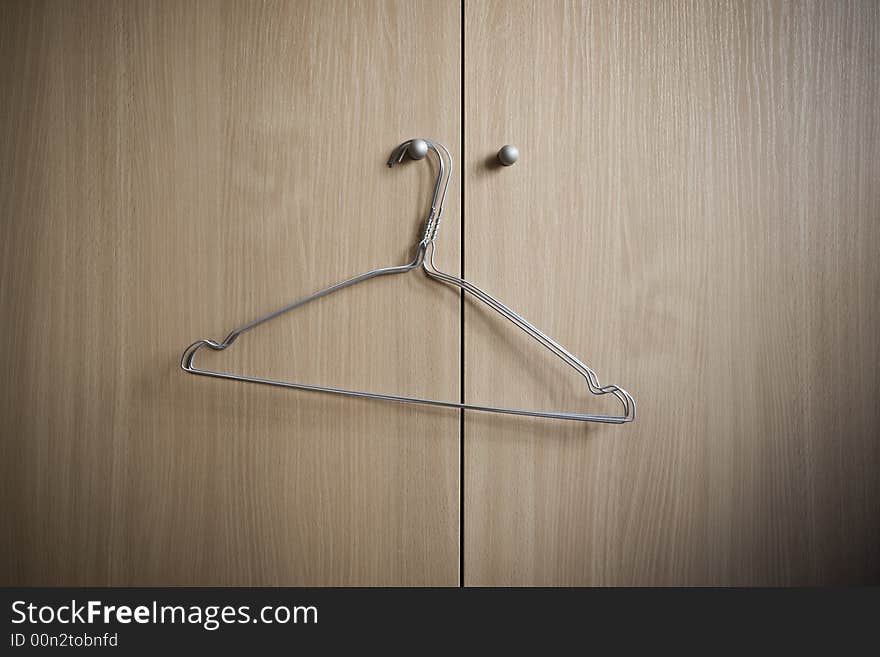 Metal hangers on the handle of a wardrobe