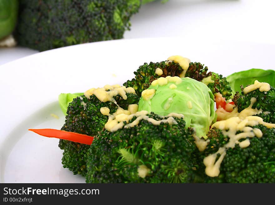 Lightly cooked broccoli pieces with a touch of but