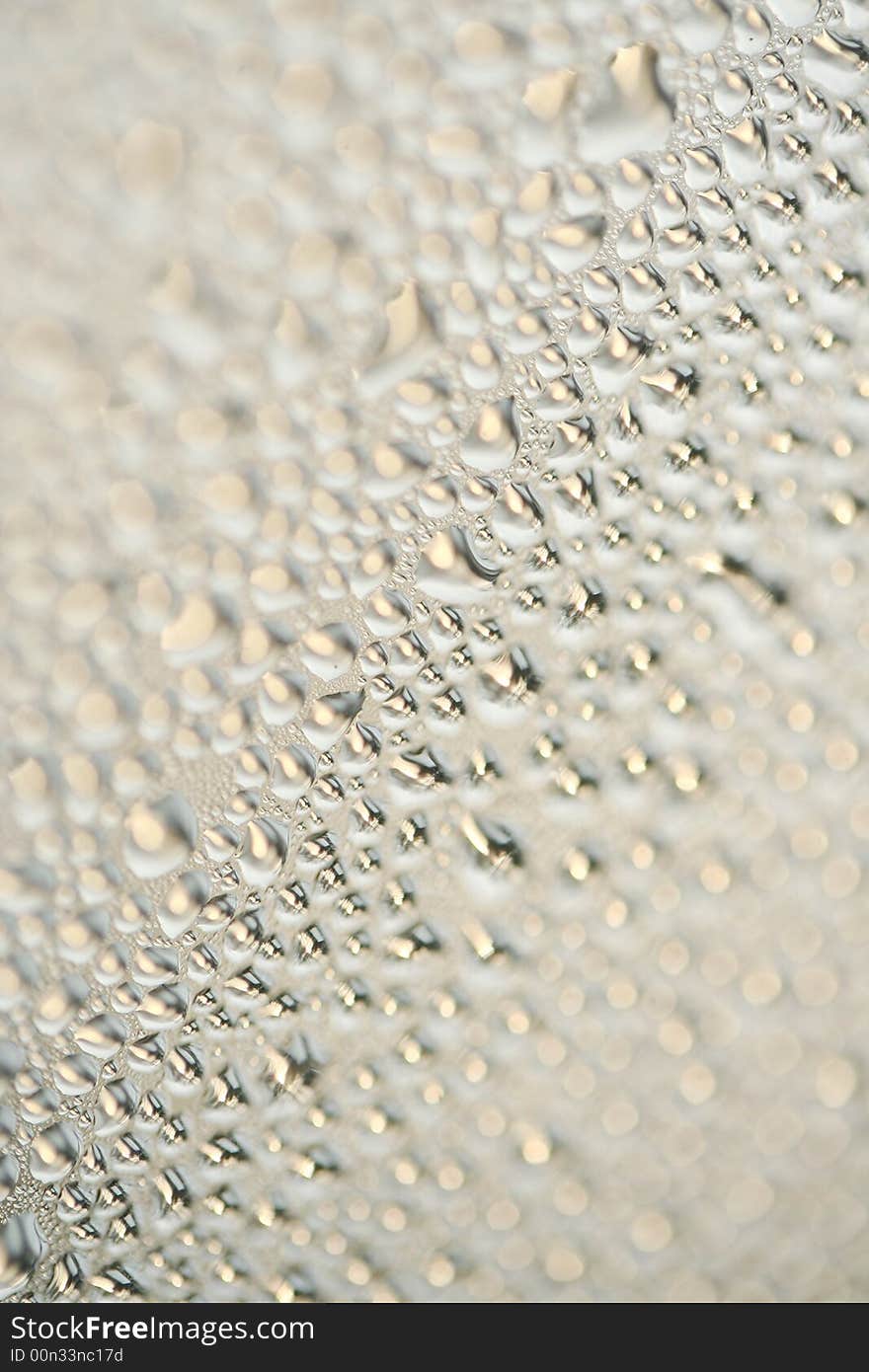 A detail of water condensed on window glass. A detail of water condensed on window glass.