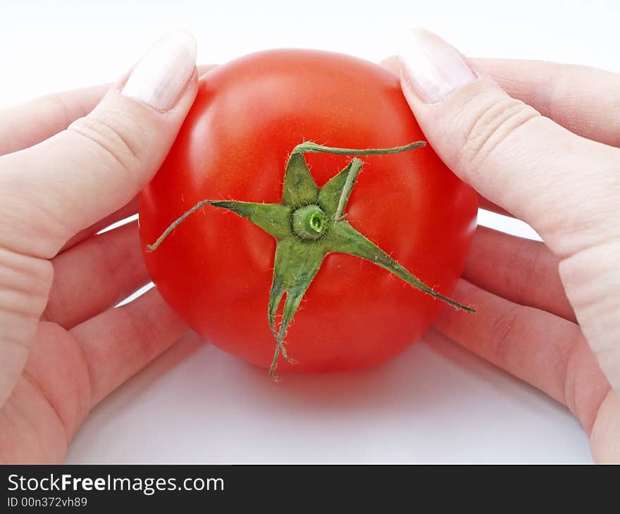 Tomato in womans hands