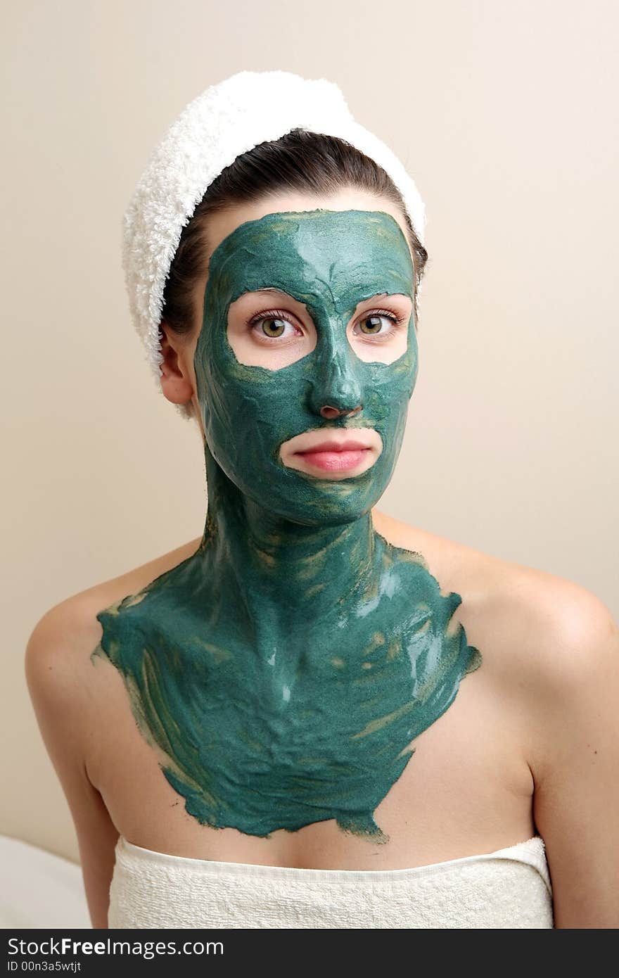 Beautyful young woman with green moisturizing facial cream. Beautyful young woman with green moisturizing facial cream