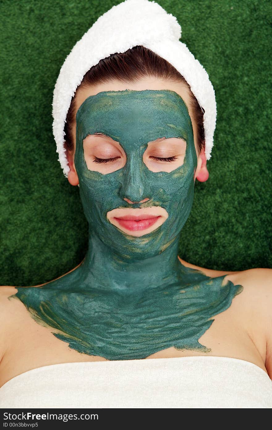 Beautyful young woman with green moisturizing facial cream. Beautyful young woman with green moisturizing facial cream