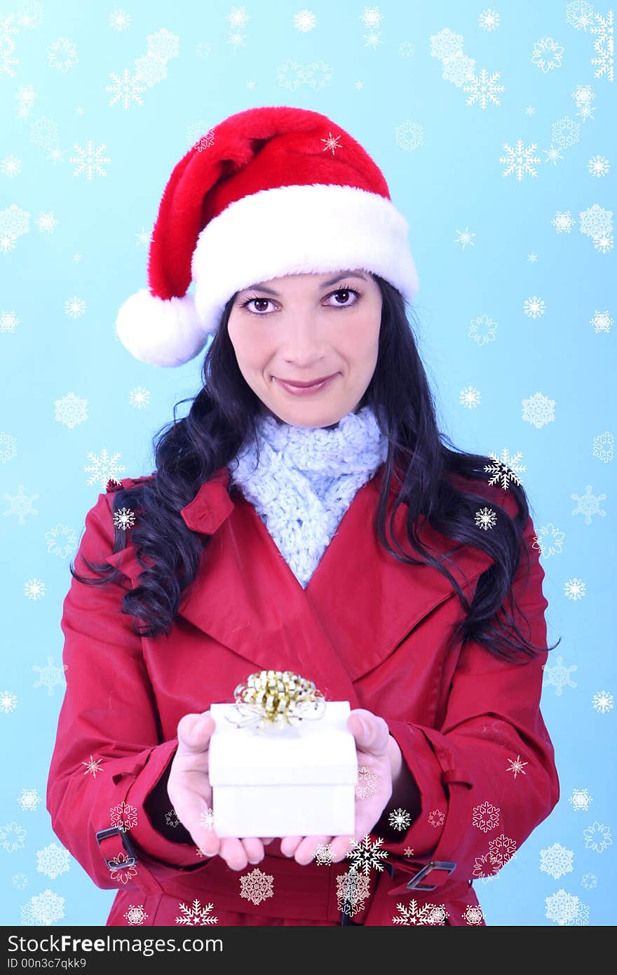 A young woman holding a Christmas gift, snowflakes surround her