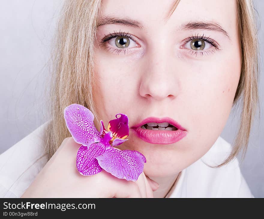 Blonde woman with orchid