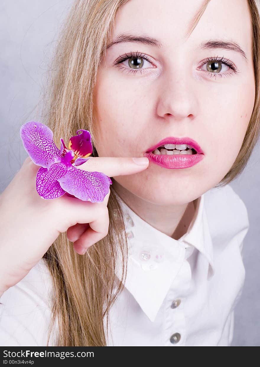 Blonde woman with orchid