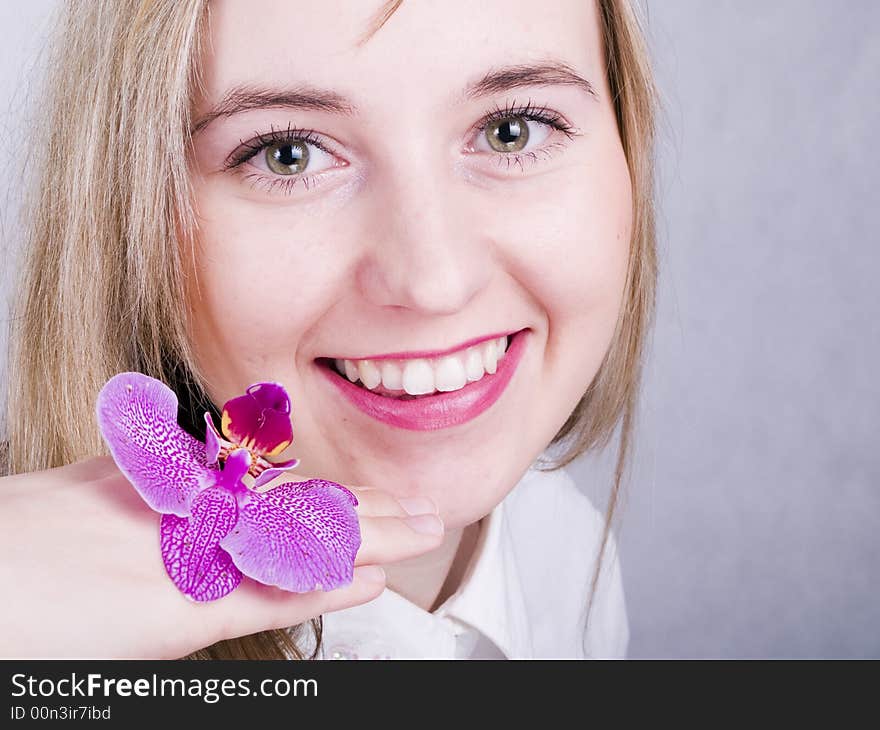 Smiling young woman with flower. Smiling young woman with flower