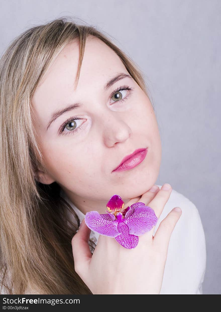 Blonde woman with orchid