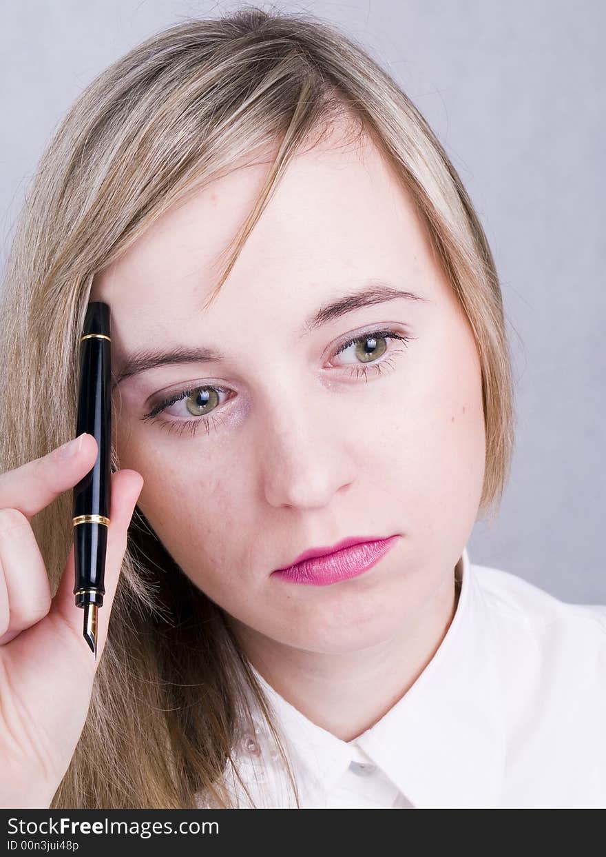 Thoughtful women holding the pen