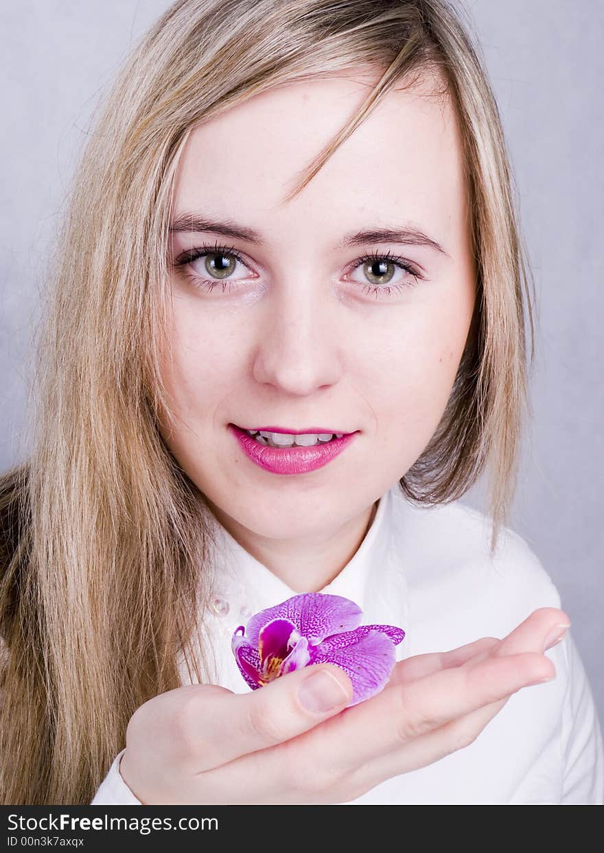 Smiling young woman with flower. Smiling young woman with flower