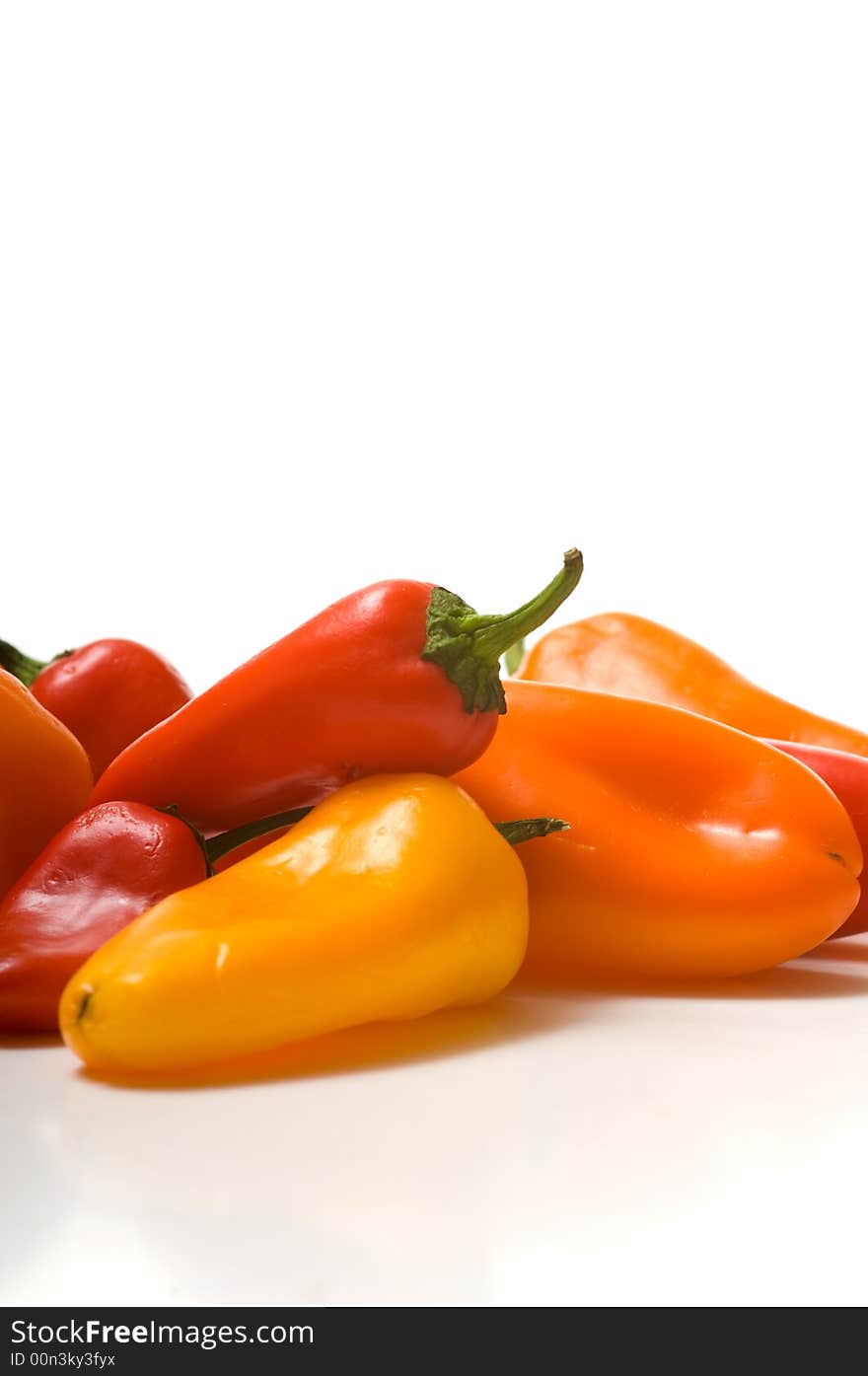 Fresh sweet peppers on white background, with copy space