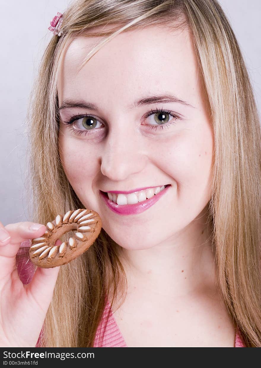 Blonde girl eating cookie