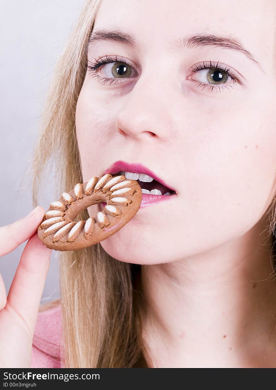 Blonde girl eating cookie