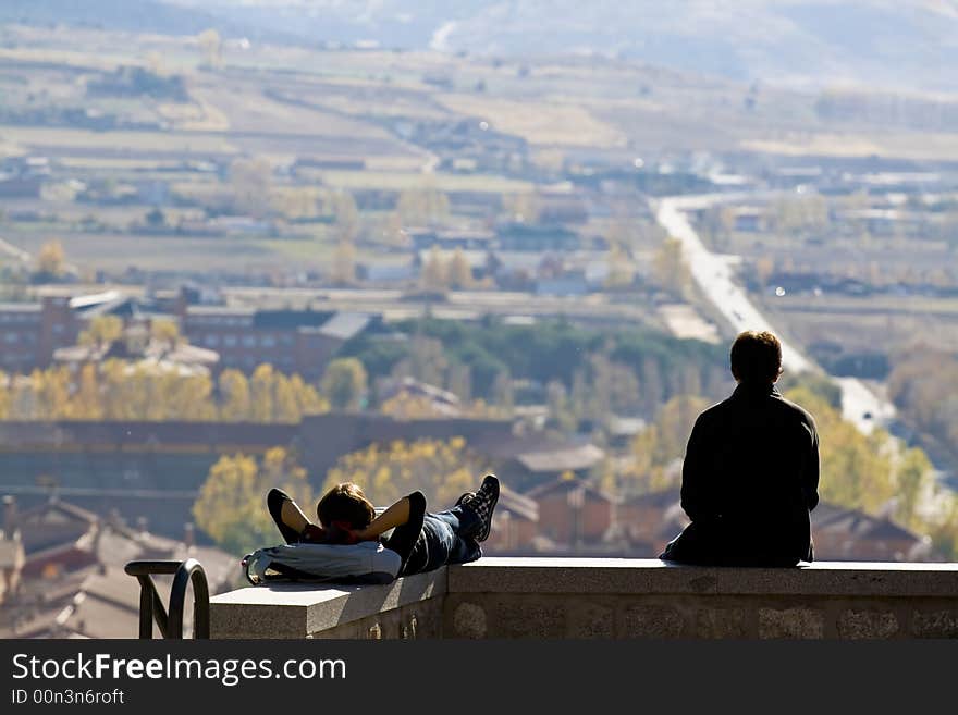 Young couple looking far away in Avila city. Young couple looking far away in Avila city.