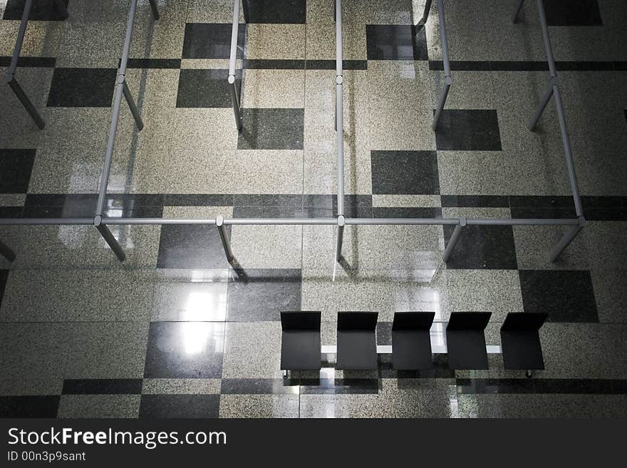 Empty rows and emty chairs, coupled with a solitude glare from the reflective glass windows on the roof. Empty rows and emty chairs, coupled with a solitude glare from the reflective glass windows on the roof.