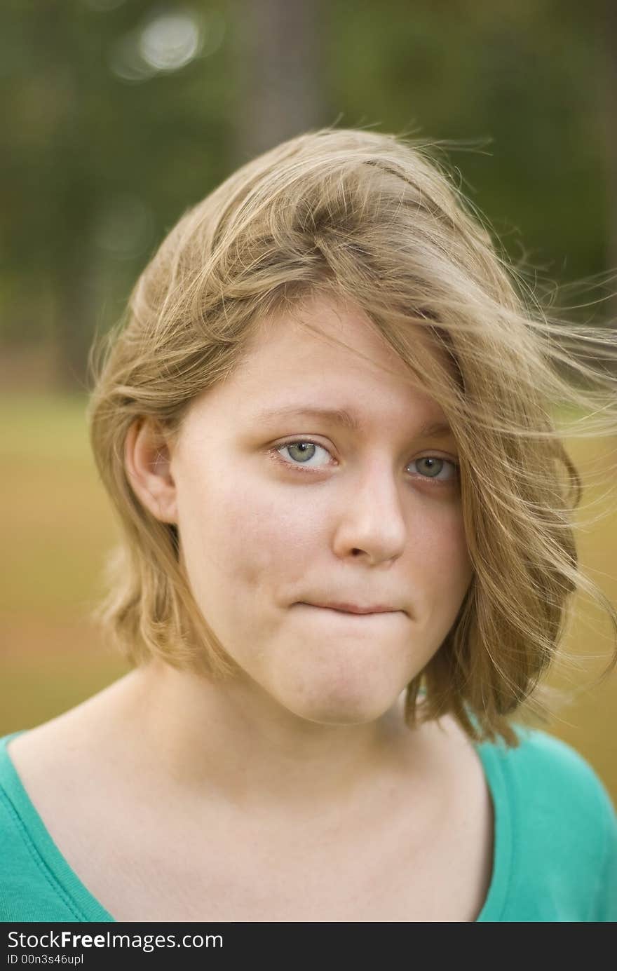 Portrait of a girl with the wind blowing through her hair. Focus is only centered around the eyes. Portrait of a girl with the wind blowing through her hair. Focus is only centered around the eyes