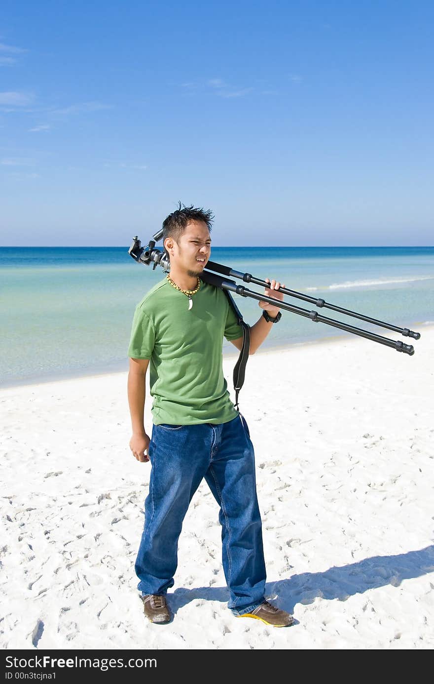 Picture of a photographer walking on the beach. Picture of a photographer walking on the beach