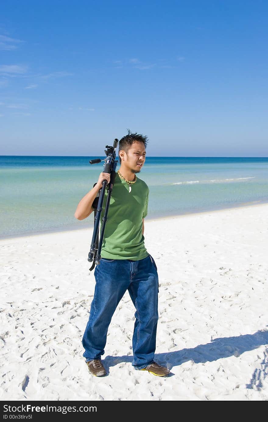 Picture of a photographer walking on the beach. Picture of a photographer walking on the beach