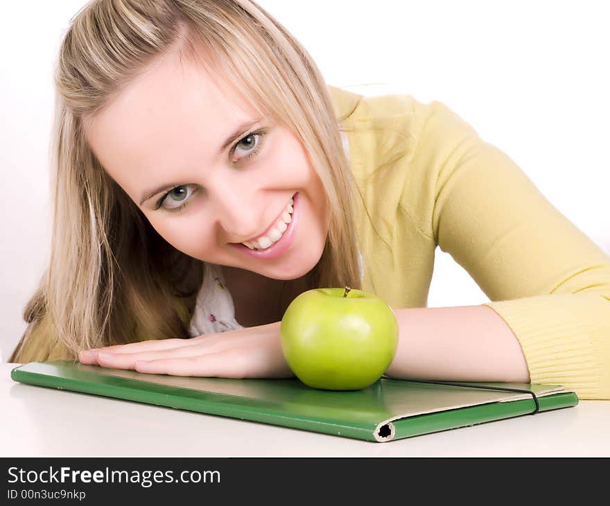 Smilling female student with green folder and apple