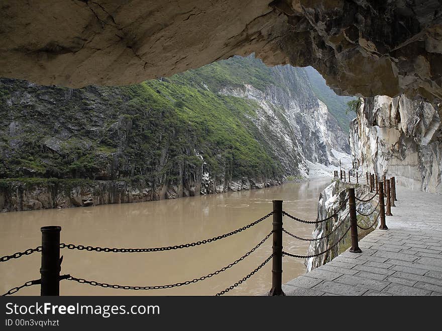 Plank road built along a cliff beside the river in Yunnan China