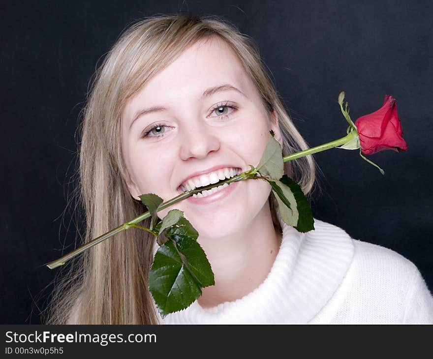 young and beautiful women with red rose in the mouth. young and beautiful women with red rose in the mouth