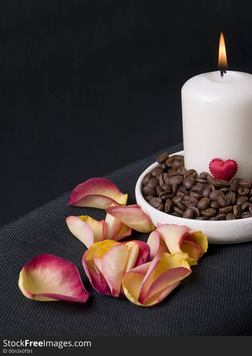 Candle, coffee beans and petals of rose