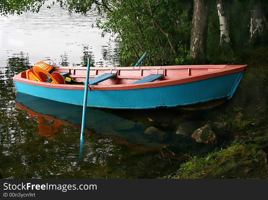 Blue boat moored to coast of the river. Blue boat moored to coast of the river.