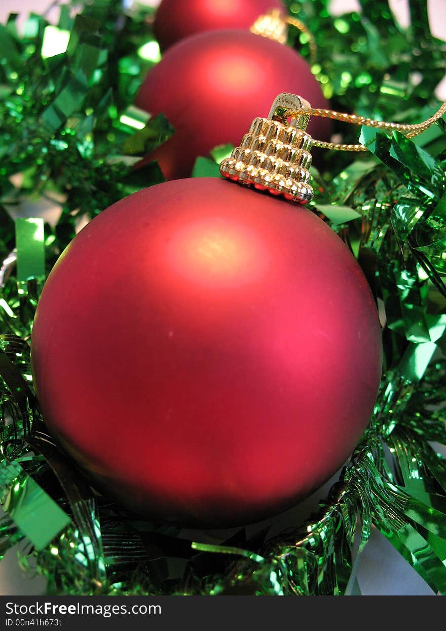 Red christmas ball on green glare background