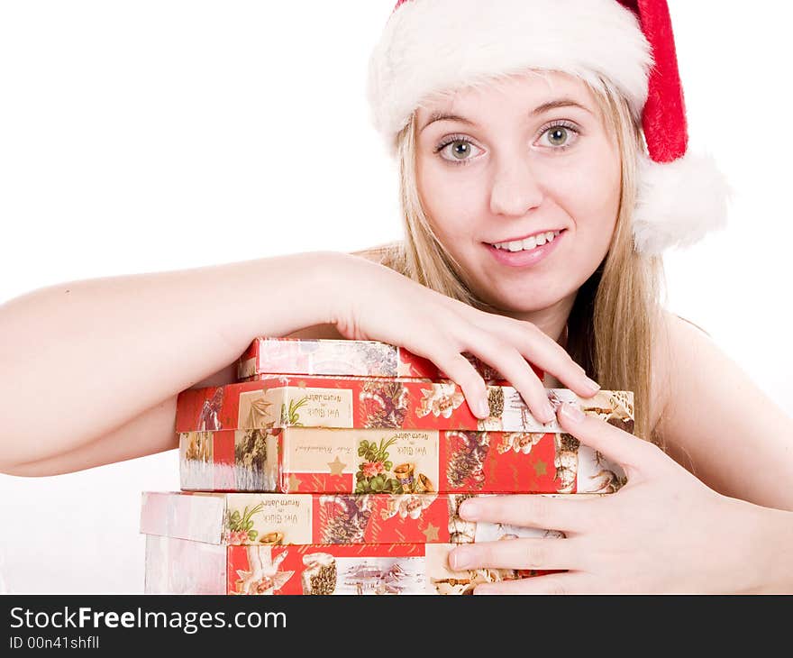 Girl In A Santa Hat And Christmas Presents.