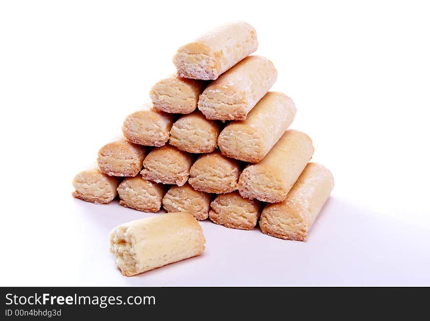 Pyramid made of fresh baked cookies with one bitten. Pyramid made of fresh baked cookies with one bitten