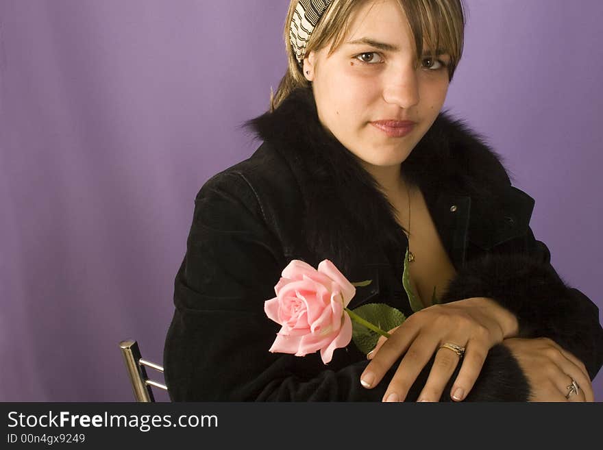 Portrait of a young attractive woman with rose