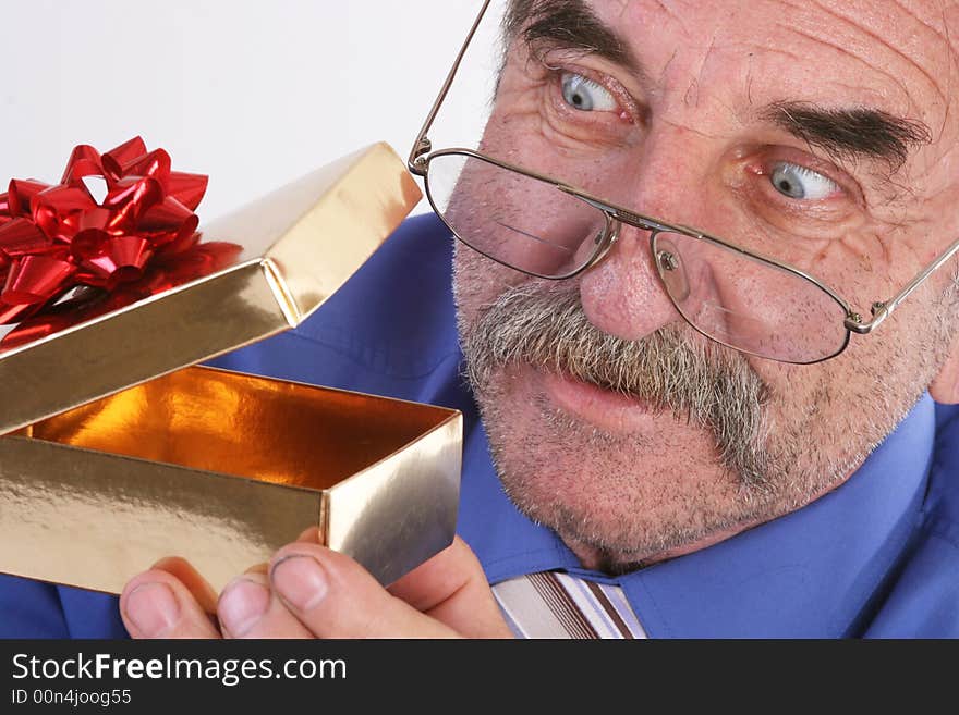 Curious man looks in a gift box. Curious man looks in a gift box.