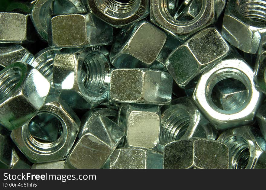 A pile of zinc plated hex nuts