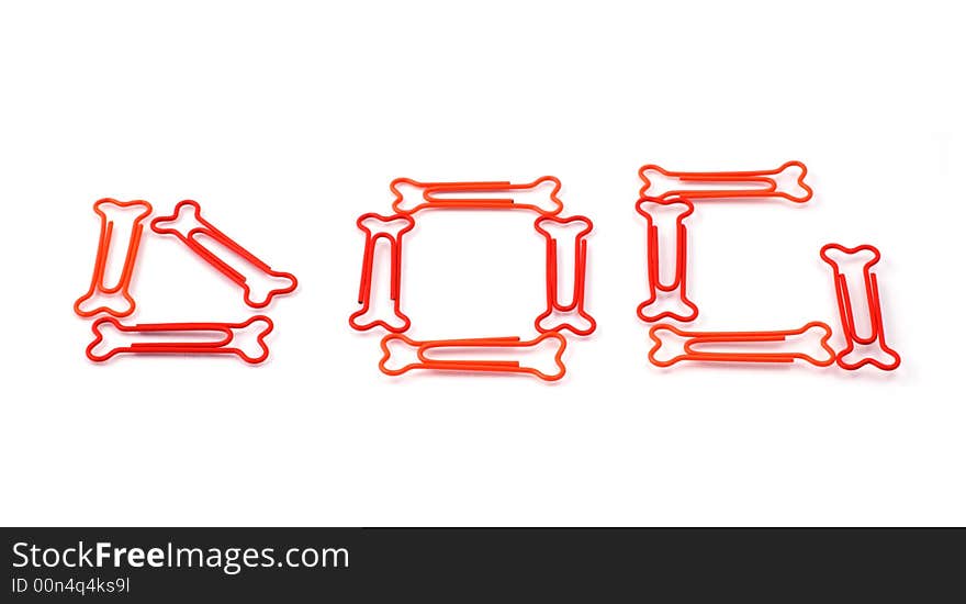 Colored bone-shaped paper clips isolated on white forming the word dog