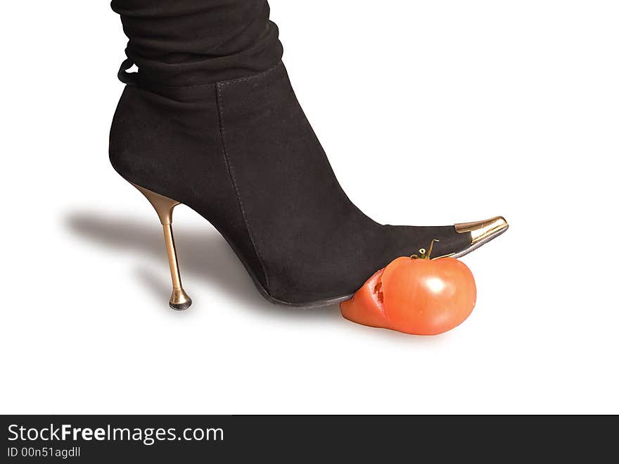 Black boots and tomato on a white background