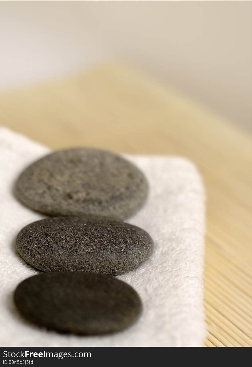 Pebble stones on white towel. Pebble stones on white towel