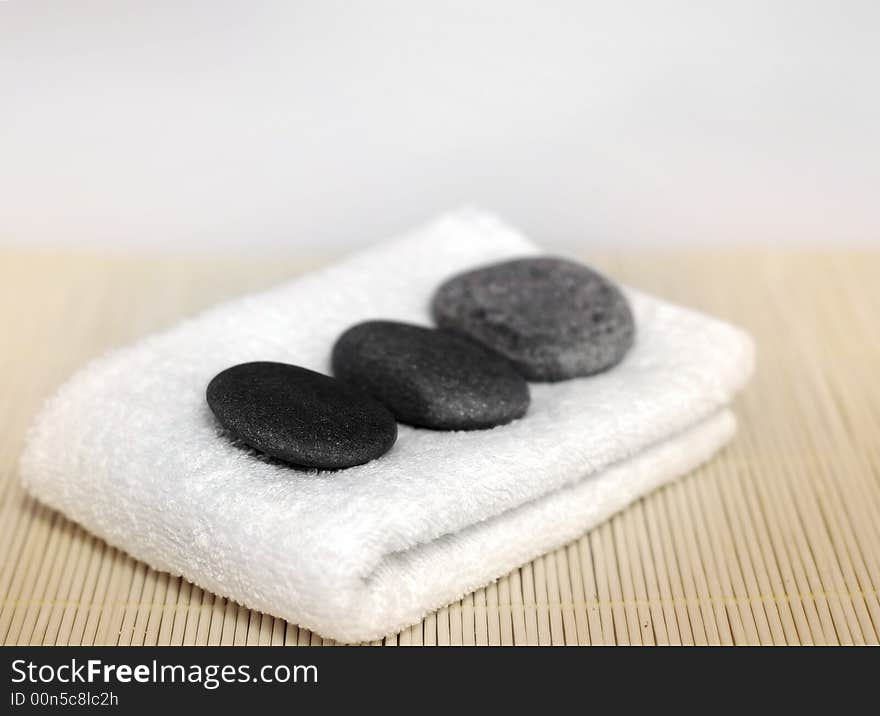 Pebble stones on white towel. Pebble stones on white towel