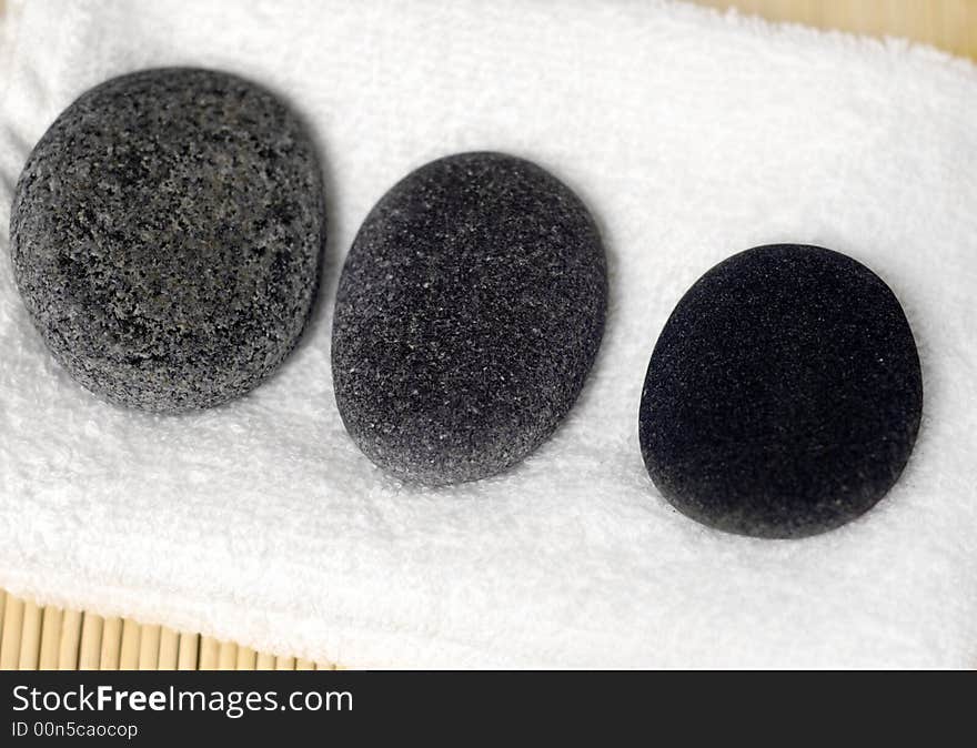 Pebble stones on white towel. Pebble stones on white towel