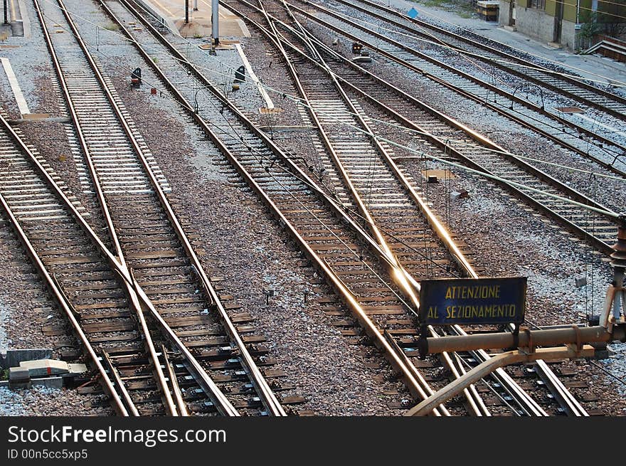 Some tracks crossing near a train station.