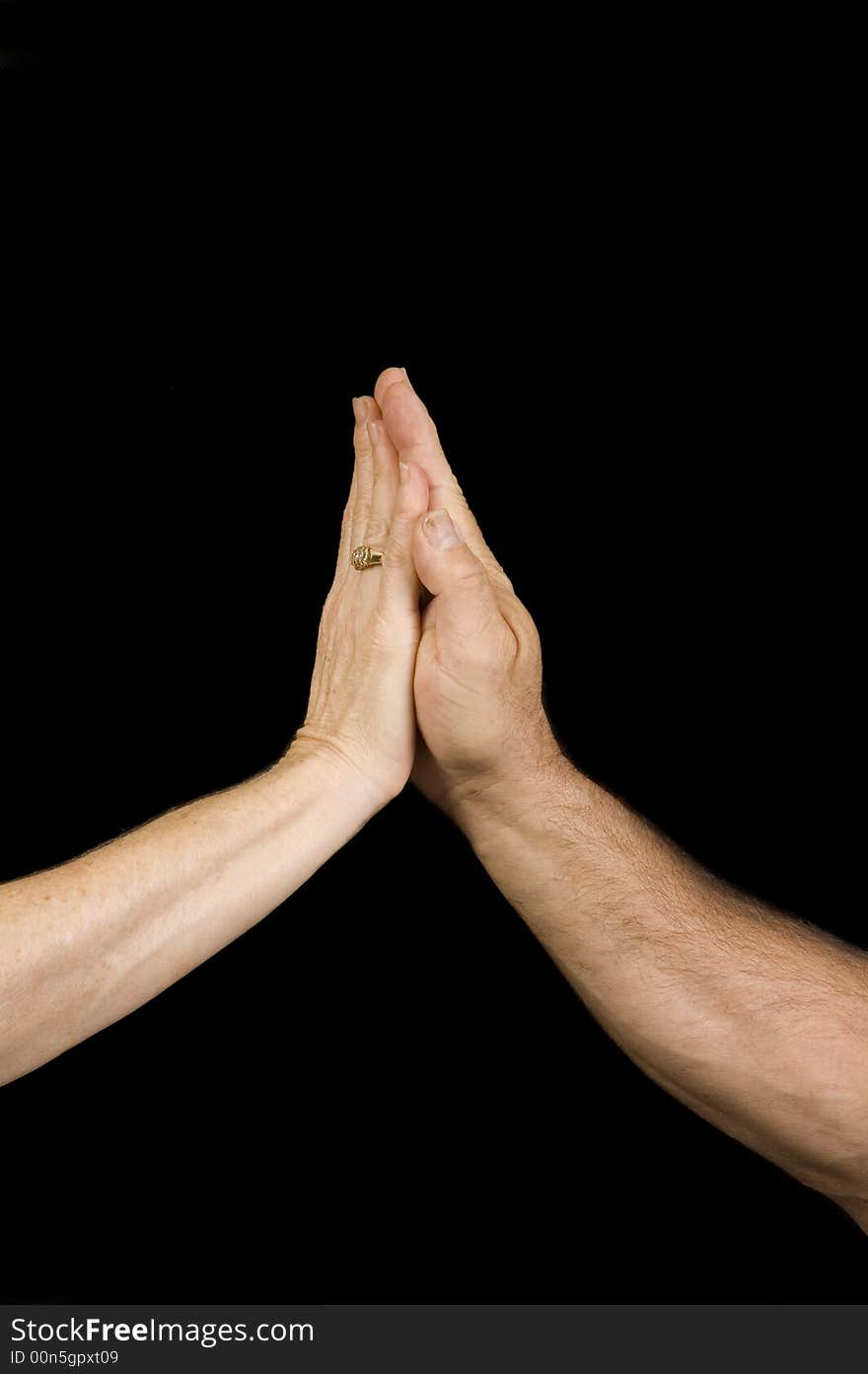 A man and woman's hands making a high five