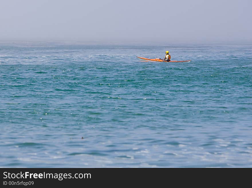 Kayaked on blue water with helmet. Kayaked on blue water with helmet