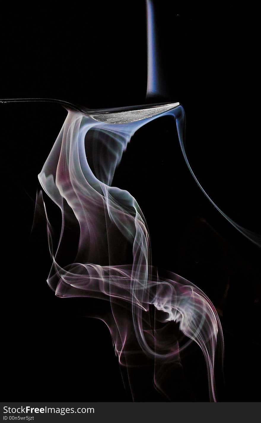 Smoke is flowing into a spoon and turning  color. Smoke is flowing into a spoon and turning  color