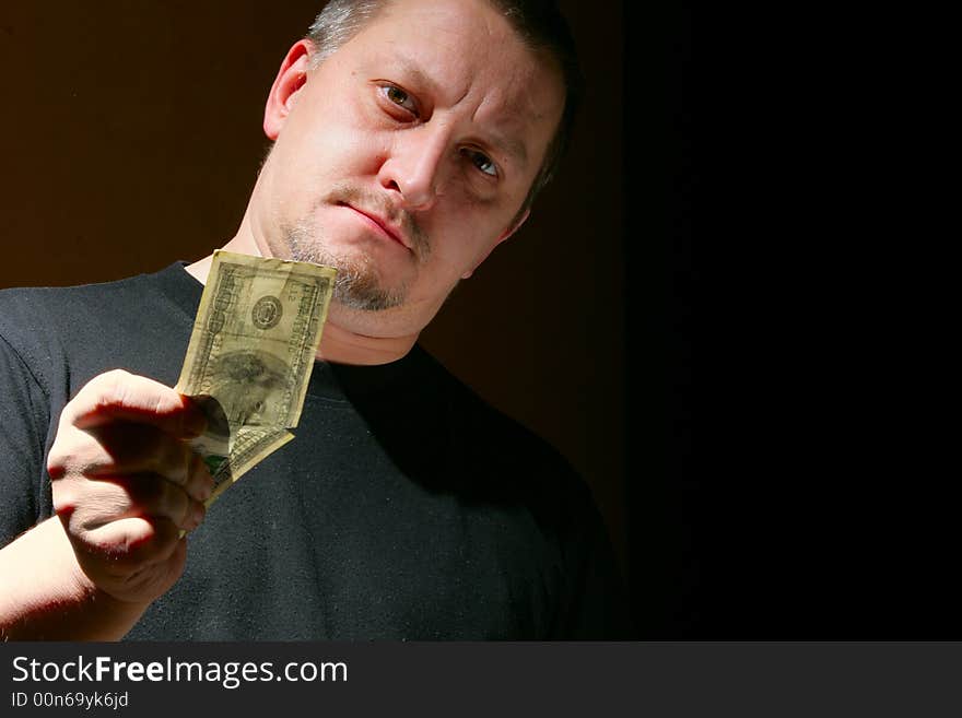 Man offering money over black background with space for your own text on right