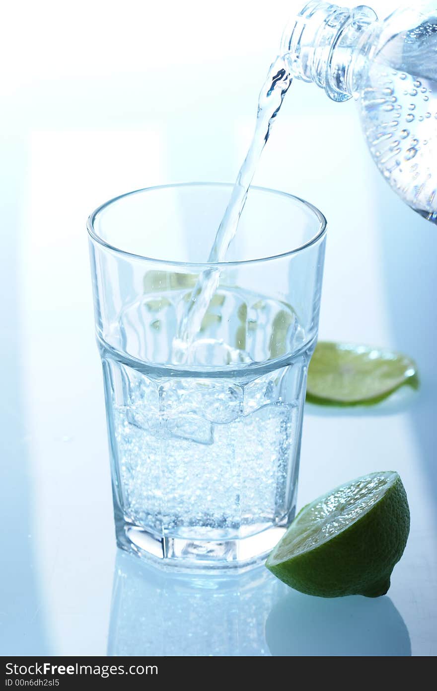 Pouring sparkling water into a glass. Pouring sparkling water into a glass