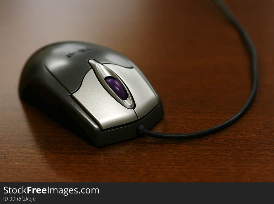 Closeup of mouse on wooden background