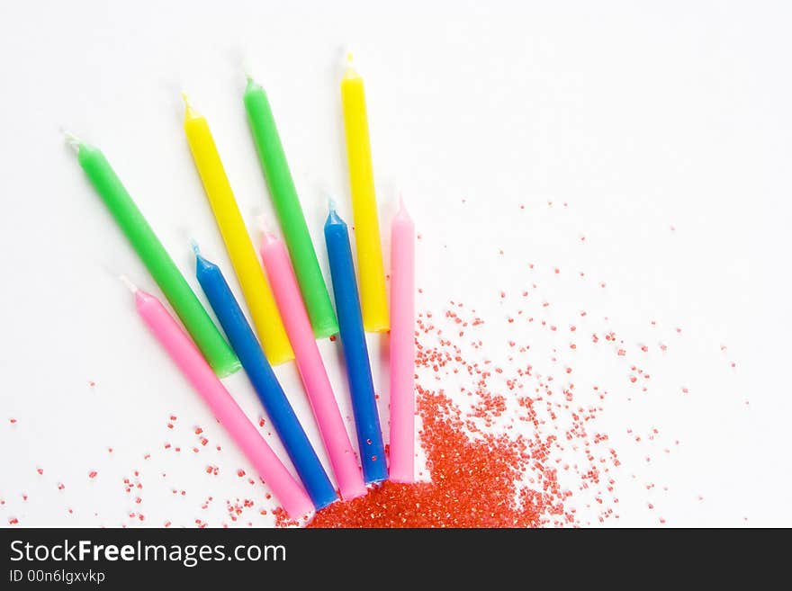 Candles and sprinkles isolated on white