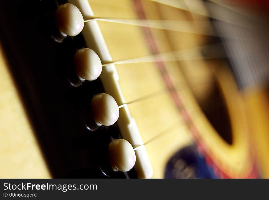 Macro of sounding board and strings of guitar. Macro of sounding board and strings of guitar